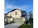 Charming two-story home featuring a well-maintained lawn and an attached two-car garage at 1635 Wynford Cir, Tavares, FL 32778
