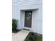 Inviting front door adorned with a decorative wreath, complementing the home's exterior at 1635 Wynford Cir, Tavares, FL 32778