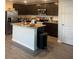 Modern kitchen with stainless steel appliances, granite countertops, and a functional island at 1635 Wynford Cir, Tavares, FL 32778
