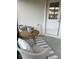 Cozy screened lanai area with wicker chairs and a small table, ideal for enjoying outdoor living at 1635 Wynford Cir, Tavares, FL 32778