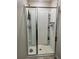 Modern walk-in shower with sleek glass doors and built-in shelving for toiletries at 1635 Wynford Cir, Tavares, FL 32778