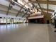 Large auditorium with a stage, wooden beams, and ample lighting at 164 Royal Palm Dr, Leesburg, FL 34748