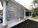 Spacious carport with modern privacy screen, ample parking and shaded area at 164 Royal Palm Dr, Leesburg, FL 34748