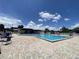 Relax at the community pool area with plenty of chairs, tables and umbrellas around at 164 Royal Palm Dr, Leesburg, FL 34748