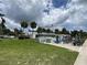 Club house with pool, picnic tables, and an American flag in a well maintained community at 164 Royal Palm Dr, Leesburg, FL 34748