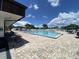 Enjoy this community pool with lounge chairs on the deck and blue skies at 164 Royal Palm Dr, Leesburg, FL 34748