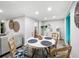 Bright dining area with round table, modern decor, and access to additional living spaces at 164 Royal Palm Dr, Leesburg, FL 34748