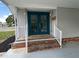 Inviting entrance featuring double doors and white railing at 164 Royal Palm Dr, Leesburg, FL 34748