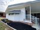 Charming home exterior featuring meticulous landscaping, a covered porch, and vinyl siding at 164 Royal Palm Dr, Leesburg, FL 34748