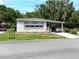 Charming single story home with covered parking and a well-maintained lawn at 164 Royal Palm Dr, Leesburg, FL 34748