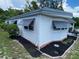 Well-maintained home exterior featuring manicured landscaping at 164 Royal Palm Dr, Leesburg, FL 34748