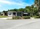 Cozy single story home featuring covered parking and a well-manicured yard at 164 Royal Palm Dr, Leesburg, FL 34748