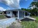 Charming single-story home boasts a covered entrance and well-maintained landscaping at 164 Royal Palm Dr, Leesburg, FL 34748