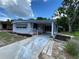 Charming single-story home boasts a covered entrance, well-maintained landscaping, and a driveway at 164 Royal Palm Dr, Leesburg, FL 34748
