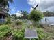 Henley Gardens sign with manicured landscaping and walking trails at 164 Royal Palm Dr, Leesburg, FL 34748