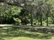 Scenic walking path surrounded by lush green landscape and natural beauty within the community at 164 Royal Palm Dr, Leesburg, FL 34748