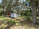 Spacious grounds with mature trees, open space for recreational activities and ample storage area at 164 Royal Palm Dr, Leesburg, FL 34748