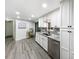 Bright kitchen with granite countertops, stainless appliances, white cabinetry, and a view to the backyard at 164 Royal Palm Dr, Leesburg, FL 34748