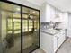 Updated kitchen with stainless appliances, granite countertops, stylish backsplash, and a sunroom view at 164 Royal Palm Dr, Leesburg, FL 34748