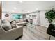 Well-lit living space with neutral decor, a glass coffee table, and a spacious seating arrangement at 164 Royal Palm Dr, Leesburg, FL 34748