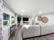 Bright and airy living area with a large sofa and windows, and stylish decor at 164 Royal Palm Dr, Leesburg, FL 34748