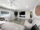 Comfortable living area with ample seating, a large television, and inviting decor at 164 Royal Palm Dr, Leesburg, FL 34748