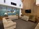 Comfortable lounge area with sofas, lamps, and a television at 164 Royal Palm Dr, Leesburg, FL 34748