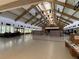 Large hall with a stage, tables, chairs, and partition screens at 164 Royal Palm Dr, Leesburg, FL 34748