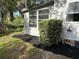 Well-maintained yard featuring mature shrubs and fresh black mulch at 164 Royal Palm Dr, Leesburg, FL 34748
