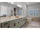 Stylish bathroom with double sinks, quartz countertops, and modern shuttered windows at 17290 Hickory Wind Dr, Clermont, FL 34711