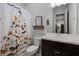 Bright bathroom featuring a dog-themed shower curtain and vanity with modern sink at 17290 Hickory Wind Dr, Clermont, FL 34711