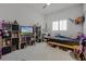 Playful bedroom with cozy decor, ceiling fan, louvred windows, and ample shelf storage at 17290 Hickory Wind Dr, Clermont, FL 34711