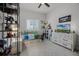 bedroom featuring playful decor, storage shelves, louvred windows, and neutral color scheme at 17290 Hickory Wind Dr, Clermont, FL 34711