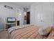 Comfortable bedroom with plush bedding, television, and access to an en-suite bathroom and closet at 17290 Hickory Wind Dr, Clermont, FL 34711