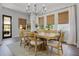 Bright dining area showcases a wood table, seating for six, bamboo shades, and modern chandelier at 17290 Hickory Wind Dr, Clermont, FL 34711