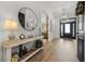 Elegant entryway featuring hardwood floors, stylish decor, and an open floor plan at 17290 Hickory Wind Dr, Clermont, FL 34711