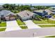 Stunning curb appeal with a well-manicured lawn, large driveway, and elegant architectural details in a well kept neighborhood at 17290 Hickory Wind Dr, Clermont, FL 34711
