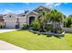 Beautiful home with a well-kept lawn and vibrant landscaping, offering great curb appeal at 17290 Hickory Wind Dr, Clermont, FL 34711