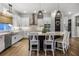 Well-lit kitchen with a large island, pendant lights, stainless steel appliances, and barstool seating at 17290 Hickory Wind Dr, Clermont, FL 34711