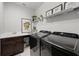 Well-equipped laundry room with modern washer and dryer and ample counter space at 17290 Hickory Wind Dr, Clermont, FL 34711