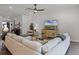 Bright living room features modern furnishings and decor, plus a ceiling fan and neutral color palette at 17290 Hickory Wind Dr, Clermont, FL 34711