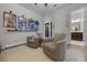 Relaxing sitting area offers comfortable seating, hardwood flooring and a door to the ensuite bathroom at 17290 Hickory Wind Dr, Clermont, FL 34711