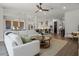 Open floor plan featuring a large sectional sofa, rug, modern decor, and an adjacent dining area at 17290 Hickory Wind Dr, Clermont, FL 34711