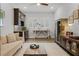 Bright living room with hardwood floors, modern lighting and a stylish bar area at 17290 Hickory Wind Dr, Clermont, FL 34711