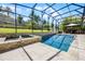 This luxurious screened pool area offers a tranquil space with a gazebo and lush backyard views at 17290 Hickory Wind Dr, Clermont, FL 34711