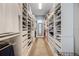 Spacious walk-in closet with custom shelving and storage solutions for clothes, shoes, and accessories at 17290 Hickory Wind Dr, Clermont, FL 34711