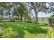 Spacious, well-maintained backyard with lush green grass, mature trees, and a charming fence line at 1785 Rushden Dr, Ocoee, FL 34761
