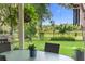 Covered patio and backyard with a grill overlooking a beautiful lake view at 1785 Rushden Dr, Ocoee, FL 34761