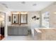 Bathroom features double sinks, soaking tub, and walk-in marble shower at 1785 Rushden Dr, Ocoee, FL 34761