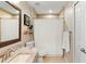 Neutral bathroom with a granite countertop vanity and a shower featuring tiled walls at 1785 Rushden Dr, Ocoee, FL 34761